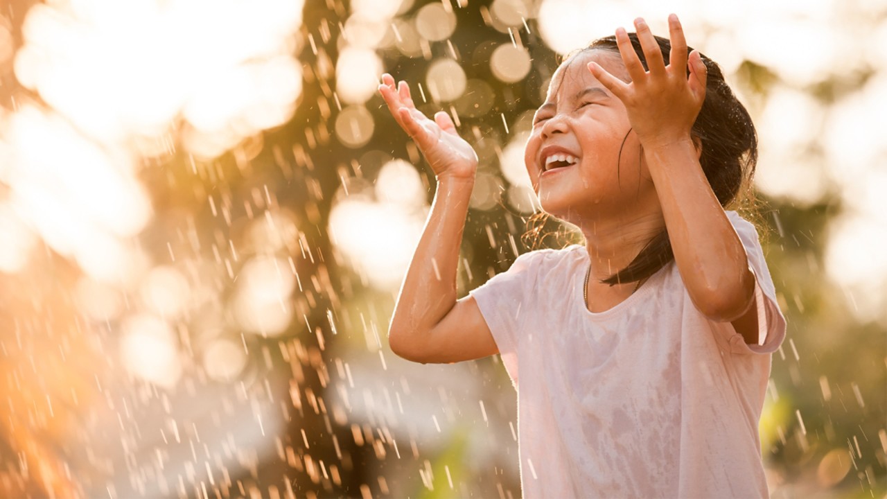 Little girl enjoying water splashes